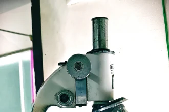 Scientist working at a scanning electron microscope in a laboratory