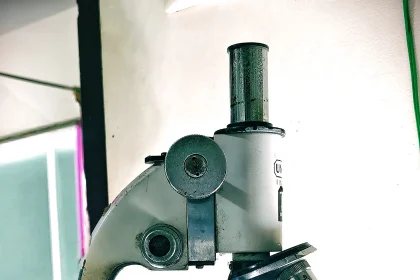 Scientist working at a scanning electron microscope in a laboratory
