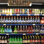 Supermarket shelf with packaged foods and nutrition labels being checked