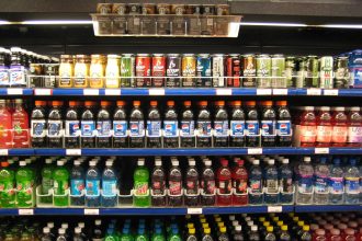 Supermarket shelf with packaged foods and nutrition labels being checked